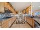 A large kitchen with granite countertops, wooden cabinets, stainless steel appliances, and ample counter space at 13007 Kuehster Rd, Littleton, CO 80127