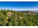 Gorgeous view of forests and rocks in the mountains with a blue sky at 13007 Kuehster Rd, Littleton, CO 80127