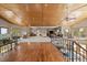 Open-concept living room boasts a wooden ceiling, multiple windows, and hardwood and carpeted floors at 13007 Kuehster Rd, Littleton, CO 80127