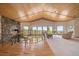 Inviting living room with a stone fireplace, carpeted floor, wood ceiling, and stunning mountain views at 13007 Kuehster Rd, Littleton, CO 80127