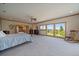 Spacious main bedroom with a ceiling fan, scenic views, and carpeted floor at 13007 Kuehster Rd, Littleton, CO 80127
