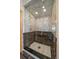 Luxurious walk-in shower with marble accents, gold fixtures, and a glass enclosure at 13007 Kuehster Rd, Littleton, CO 80127