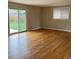 Bright living room features beautiful hardwood floors and a sliding glass door to the backyard at 7123 Winona Ct, Westminster, CO 80030