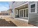 A covered patio area with sliding glass doors leading to the home's interior at 5319 Warrior St, Frederick, CO 80504