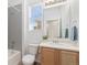 Bright bathroom featuring tile flooring, large mirror, and tub with shower at 5319 Warrior St, Frederick, CO 80504