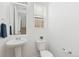 Bright white bathroom with pedestal sink and convenient towel rack at 5319 Warrior St, Frederick, CO 80504