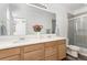 Modern bathroom with dual vanity, updated fixtures, and enclosed shower at 5319 Warrior St, Frederick, CO 80504