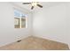 Simple bedroom with plush carpet, ceiling fan, and large window at 5319 Warrior St, Frederick, CO 80504