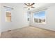 Bright bedroom with plush carpet, ceiling fan, and large windows at 5319 Warrior St, Frederick, CO 80504