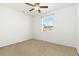 Unfurnished bedroom with plush carpet, ceiling fan, and window at 5319 Warrior St, Frederick, CO 80504