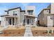 Contemporary home with neutral siding, stone accents and a well-manicured gravel front yard with inviting concrete pathway at 5319 Warrior St, Frederick, CO 80504