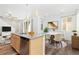 Open-concept kitchen with breakfast bar, with adjoining dining and living spaces, creates an inviting and functional layout at 5319 Warrior St, Frederick, CO 80504