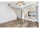Bright living room with wood floors, sliding patio doors, and an open staircase at 5319 Warrior St, Frederick, CO 80504