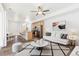Bright open-concept living space with modern furnishings, sleek hardwood floors, and eat-in kitchen with stainless appliances at 5319 Warrior St, Frederick, CO 80504