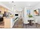 Modern open-concept living space with breakfast bar, cozy dining area, and ample natural light, with stainless appliances at 5319 Warrior St, Frederick, CO 80504