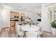Modern open-concept layout with kitchen island, stainless appliances, adjacent to dining and living spaces at 5319 Warrior St, Frederick, CO 80504