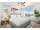 Relaxing main bedroom with neutral walls, large windows, ceiling fan, and area rug at 5319 Warrior St, Frederick, CO 80504