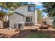 Exterior view of a two-story home with a deck, grill, outdoor furniture, and well-maintained backyard at 7633 Gray Way, Arvada, CO 80003