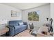 Comfortable office space featuring a sleeper sofa, desk, and a view of the treelined outdoors at 7633 Gray Way, Arvada, CO 80003