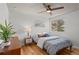 Inviting bedroom with hardwood floors, a ceiling fan, and natural light from a large window at 7633 Gray Way, Arvada, CO 80003