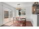 Bright dining area featuring a modern table, chairs, and sliding door to the outdoor deck at 7633 Gray Way, Arvada, CO 80003