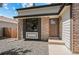Close up on the home's entrance showcasing the front door and decorative brickwork at 7633 Gray Way, Arvada, CO 80003