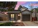 Charming two-story home featuring a brick facade, well-manicured lawn, and attached garage at 7633 Gray Way, Arvada, CO 80003
