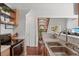Cozy kitchen featuring stainless appliances, hardwood floors and seamless view of the living room at 7633 Gray Way, Arvada, CO 80003