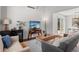 Cozy living room featuring comfortable seating, stylish decor, and a view into the dining area at 7633 Gray Way, Arvada, CO 80003