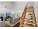 Bright living room featuring hardwood floors, modern decor, and an open staircase at 7633 Gray Way, Arvada, CO 80003