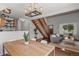 Inviting living space featuring dining area, staircase, and a cozy sofa at 7633 Gray Way, Arvada, CO 80003