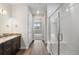Bathroom with tile flooring, double vanity, tiled shower with glass door, and white tiled wall at 2149 Peralta Loop, Castle Rock, CO 80104