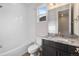 Bright bathroom featuring a shower-tub combination, white subway tiles, and a granite-topped vanity with dark cabinets at 2149 Peralta Loop, Castle Rock, CO 80104