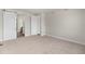 Neutral bedroom with a sliding barn door, plush carpet, and a walk-in closet at 2149 Peralta Loop, Castle Rock, CO 80104