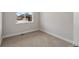 Cozy carpeted bedroom with trim, baseboard heat, and a view overlooking neighboring houses at 2149 Peralta Loop, Castle Rock, CO 80104