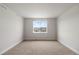 A serene bedroom with carpet flooring and a window offering views of the neighborhood at 2149 Peralta Loop, Castle Rock, CO 80104