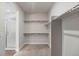 Walk-in closet with shelves and rods near a bathroom with a glass enclosed shower at 2149 Peralta Loop, Castle Rock, CO 80104