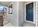 A close up of the home's blue entry door and covered porch at 2149 Peralta Loop, Castle Rock, CO 80104