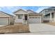 Charming single-Gathering home features stone accents, covered porch, and attached two car garage at 2149 Peralta Loop, Castle Rock, CO 80104