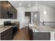 Modern kitchen with dark cabinetry, granite countertops, stainless appliances, and a large island with sink at 2149 Peralta Loop, Castle Rock, CO 80104