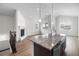 Open-concept living room featuring a fireplace, large windows with neighborhood views, and wood flooring at 2149 Peralta Loop, Castle Rock, CO 80104