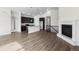Bright, open-concept living space with a modern fireplace, wood floors, and stylish kitchen featuring a large center island at 2149 Peralta Loop, Castle Rock, CO 80104