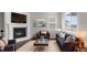 Staged living room features a fireplace, windows, and stylish decor for a welcoming ambiance at 2149 Peralta Loop, Castle Rock, CO 80104