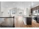 Spacious living area with wood flooring, white walls, kitchen with island, and stairwell access at 2149 Peralta Loop, Castle Rock, CO 80104