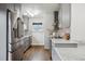 Modern gray kitchen featuring stainless steel appliances, and marble countertops at 1360 Pontiac St, Denver, CO 80220