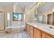 Bathroom with double sinks, a tub, and a glass-door shower at 5863 S Danube St, Aurora, CO 80015