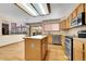 Bright kitchen with wood cabinets, stainless steel appliances, and a large island at 5863 S Danube St, Aurora, CO 80015