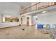 Open concept living room with a view of the kitchen, high ceilings, and access to other areas of the home at 5863 S Danube St, Aurora, CO 80015