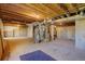 Unfinished basement with water heater, exposed pipes, and stairs leading to upper level at 22739 E Prentice Pl, Aurora, CO 80015