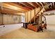 Unfinished basement space with exposed beams, stairs and a window providing natural light at 22739 E Prentice Pl, Aurora, CO 80015